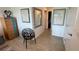 Bright hallway features wood floors, designer decor, and a stylish black tree-branch design chair at 244 & 243 Mariner Dr # 243-244, Tarpon Springs, FL 34689