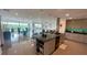 Open-concept kitchen and dining area featuring sleek countertops, modern appliances, and stunning views at 244 & 243 Mariner Dr # 243-244, Tarpon Springs, FL 34689