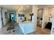 Spacious open kitchen with a large granite island featuring bar seating, pendant lighting, and modern finishes at 244 & 243 Mariner Dr # 243-244, Tarpon Springs, FL 34689