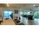 Bright living room with tile floors, ceiling fans, and sliding glass doors to the balcony, blending indoor/outdoor living at 244 & 243 Mariner Dr # 243-244, Tarpon Springs, FL 34689