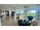 Spacious living area with open layout, sleek tile floors, balcony access, and comfortable seating at 244 & 243 Mariner Dr # 243-244, Tarpon Springs, FL 34689