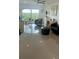 Stylish living room features gray tile floors, comfortable seating, and a beautiful outdoor view at 244 & 243 Mariner Dr # 243-244, Tarpon Springs, FL 34689