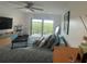 Serene main bedroom boasts a balcony with treetop views, ceiling fan, and modern decor at 244 & 243 Mariner Dr # 243-244, Tarpon Springs, FL 34689