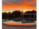 Sparkling pool with covered lounge area, reflecting the vibrant colors of the sunset at 244 & 243 Mariner Dr # 243-244, Tarpon Springs, FL 34689