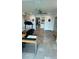 Multi-purpose room with exercise equipment, desk, and neutral tile flooring, ideal for a home office or gym at 244 & 243 Mariner Dr # 243-244, Tarpon Springs, FL 34689