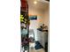 Small storage closet with shelving and a work surface, perfect for tools and household maintenance at 244 & 243 Mariner Dr # 243-244, Tarpon Springs, FL 34689