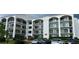 Elegant multi-story building with white facade, arched balconies, and well-maintained landscaping at 244 Mariner Dr, Tarpon Springs, FL 34689