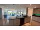Modern kitchen with granite countertops open to the living and dining areas and gorgeous exterior views at 244 Mariner Dr, Tarpon Springs, FL 34689