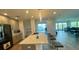 Bright, spacious kitchen with bar seating, granite countertops, and an open layout to the living area at 244 Mariner Dr, Tarpon Springs, FL 34689