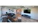 Spacious living room featuring tile flooring, modern decor, and ample seating for entertaining at 244 Mariner Dr, Tarpon Springs, FL 34689