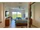 Comfortable main bedroom showcasing a large mirror, ceiling fan, balcony access with nature views, and modern decor at 244 Mariner Dr, Tarpon Springs, FL 34689