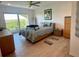 Inviting main bedroom with wood-look floors, ceiling fan, balcony access, and comfortable furnishings at 244 Mariner Dr, Tarpon Springs, FL 34689