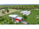 Aerial view of property with the house, barn, surrounding greenery, and fencing that enhance its appeal at 28410 Wildlife Ln, Brooksville, FL 34602