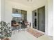 Comfortable back porch featuring chairs, table and sliding glass doors at 28410 Wildlife Ln, Brooksville, FL 34602