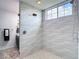 Modern shower design with unique textured tile and premium shower fixtures at 28410 Wildlife Ln, Brooksville, FL 34602