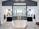 Luxurious primary bathroom featuring a soaking tub and dual vanities for relaxation at 28410 Wildlife Ln, Brooksville, FL 34602