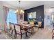 Sophisticated dining room with a chandelier, a black accent wall, and seating for six at 28410 Wildlife Ln, Brooksville, FL 34602