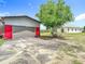 Exterior shot of the house and the barn, with a long driveway at 28410 Wildlife Ln, Brooksville, FL 34602