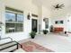 Spacious front porch featuring comfortable seating, stylish decor, and elegant sconces at 28410 Wildlife Ln, Brooksville, FL 34602