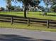 Charming horse property with wooden fencing and a horse grazing in the front yard at 28410 Wildlife Ln, Brooksville, FL 34602