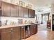 Modern kitchen wet bar area with sleek cabinets, countertop, wine cooler, and an open view to the living room at 28410 Wildlife Ln, Brooksville, FL 34602