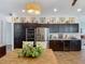 Beautiful kitchen with stainless steel appliances, dark cabinets, and center island, perfect for entertaining and meal prep at 28410 Wildlife Ln, Brooksville, FL 34602