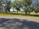Nice view of a horse grazing in a green pasture surrounded by trees and fencing at 28410 Wildlife Ln, Brooksville, FL 34602