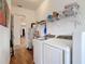 Functional laundry room with modern washer, dryer, and storage shelves at 28410 Wildlife Ln, Brooksville, FL 34602