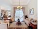 Comfortable living room area with a floral sofa, seating, a chandelier, and a view to the outdoor patio at 28410 Wildlife Ln, Brooksville, FL 34602