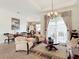 Bright and airy living room featuring neutral tones, comfortable seating, and a view to an outdoor area at 28410 Wildlife Ln, Brooksville, FL 34602