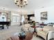Expansive open-concept living area with elegant decor, a piano, and multiple seating areas for entertaining guests at 28410 Wildlife Ln, Brooksville, FL 34602