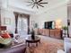Spacious living room with a detailed cabinet, area rug, couch, and decor, perfect for relaxing and entertaining at 28410 Wildlife Ln, Brooksville, FL 34602
