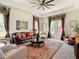 Comfortable living room featuring a leather couch, detailed area rug, and natural light, creating a welcoming space at 28410 Wildlife Ln, Brooksville, FL 34602