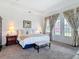A light, spacious main bedroom featuring double doors and a comfortable seating area at 28410 Wildlife Ln, Brooksville, FL 34602