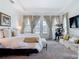 Bright main bedroom with a comfortable seating area, doors, and lots of light at 28410 Wildlife Ln, Brooksville, FL 34602