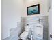 Unique powder room featuring modern toilet and urinal fixtures, and wall art at 28410 Wildlife Ln, Brooksville, FL 34602