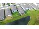 Aerial view of residences with fenced yards, and a pond, highlighting community's natural surroundings at 3329 Fresno Pl, Zephyrhills, FL 33541