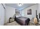 Compact bedroom featuring carpet floors with airplane-themed wall art and simple furnishings at 3329 Fresno Pl, Zephyrhills, FL 33541