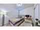 Neutral bedroom with carpet flooring and a tufted headboard bed next to a small work desk at 3329 Fresno Pl, Zephyrhills, FL 33541