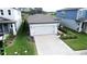 Aerial view of a well-maintained home featuring a spacious driveway and neatly manicured lawn at 3329 Fresno Pl, Zephyrhills, FL 33541