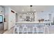 Bright kitchen with large island, white cabinets, stainless steel appliances, and modern fixtures at 3329 Fresno Pl, Zephyrhills, FL 33541