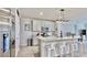 Contemporary kitchen with stainless steel appliances, granite countertops, and an island with barstool seating at 3329 Fresno Pl, Zephyrhills, FL 33541