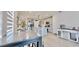 Open-concept kitchen featuring a large island, stainless steel appliances, and ample dining space at 3329 Fresno Pl, Zephyrhills, FL 33541
