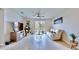 Bright living room featuring a ceiling fan, a white leather sofa and decoratively displayed Christmas tree at 3329 Fresno Pl, Zephyrhills, FL 33541
