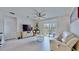 Cozy living room with a sliding glass door, neutral palette, and stylish ceiling fan at 3329 Fresno Pl, Zephyrhills, FL 33541