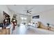 Inviting living room featuring wood-look floors, neutral walls, and a sliding door offering scenic views at 3329 Fresno Pl, Zephyrhills, FL 33541
