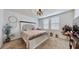 A charming main bedroom boasts a tufted headboard bed frame, soft carpet, and a round decorative chandelier at 3329 Fresno Pl, Zephyrhills, FL 33541