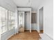 Bright bedroom featuring wood-look floors, white walls, and mirrored sliding closet doors at 3333 26Th E Ave # 1090, Bradenton, FL 34208