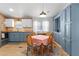 Charming dining area with updated light fixture, seamlessly flowing into the kitchen at 3333 26Th E Ave # 1090, Bradenton, FL 34208