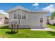 Charming home featuring light gray siding, bay window, and well-maintained lawn at 3333 26Th E Ave # 1090, Bradenton, FL 34208